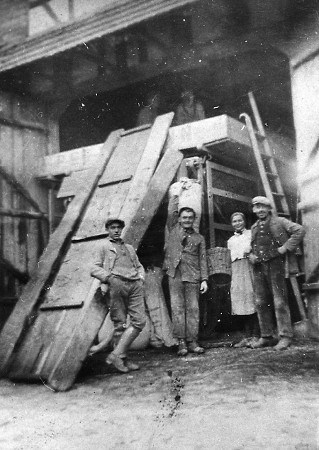 Dreschhelfer vor einer Dreschmaschine in Hauptschwenda, um 1935