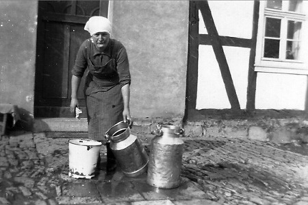 Frau in Wetterburg beim Kannenspülen, um 1935