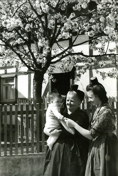 Mutter und Großmutter in Schwälmer Tracht mit Kleinkind, 1950er Jahre