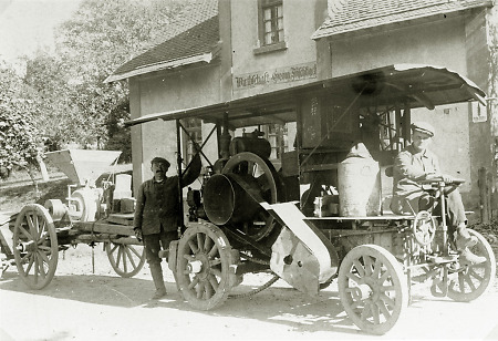 Zwei Männer mit einer Maschine vor einer Gastwirtschaft in Lollar, 1930